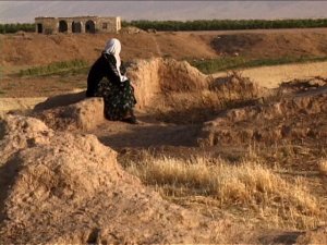 Kirmanj Gundi’s mother surveys the ruins of a village where her relatives lived.  