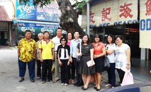 Dr. Zeny Panol (center, wearing black and white) with faculty and students in Malaysia.