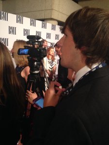 The Music City Project's Zach Ward monitors questions and answers in preparation for live tweeting from the red carpet at the BMI Awards Nov. 4.