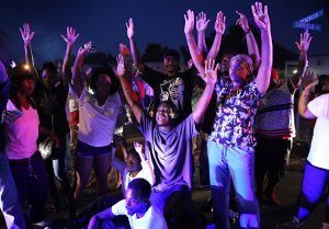 "Don't shoot us," cry protestors as they confront police officers arriving to break up a crowd on Canfield Dr. in Ferguson on Saturday, Aug. 9, 2014.  Earlier in the day police had shot and killed an 18-year-old man on the street. Photo by David Carson.