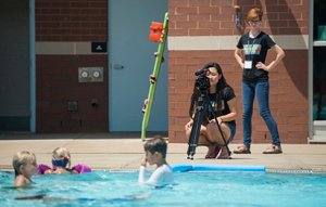 Sophia Chen from MLK Magnet Charter School records B-roll for a video project at the Campus Recreation Center outdoor pool during the Innovation J-Camp in July.